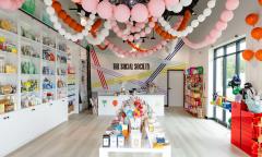 The store's inside with balloons hanging from the ceiling