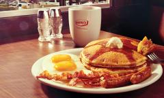 A breakfast plate with a cup of coffee