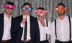 A group of men acting goofy in a photo booth