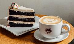 A chocolate cake and coffee mug served on plates