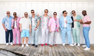 Straight No Chaser wears colorful clothing and poses for the camera. 