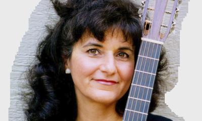 Jeanie Fitchen with her folksong-playing guitar