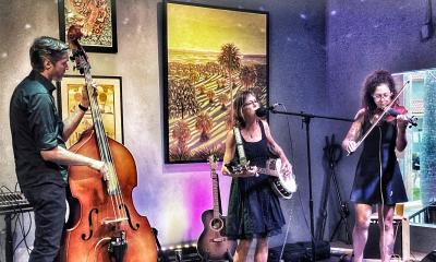 band SouthPaw, man on bass, woman on banjo, woman on fiddle, onstage