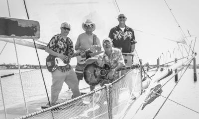 The band posing together on a boat