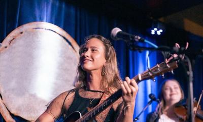 Indie-folk sogwriter Brooke Garwood onstage, smiling