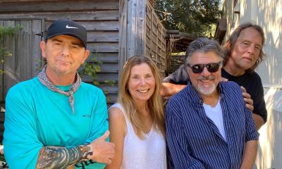 The four members of the Carpet Baggers band, standing in Colonial Oak Music Park