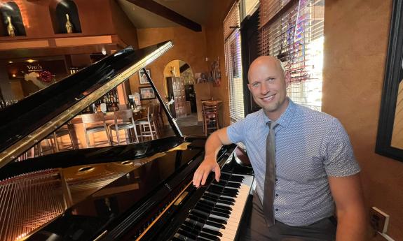 Pianist Jeremy Weinglass seated in front of the piano. 