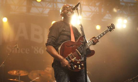 Mr. SIPP plays the guitar while singing the blues. 