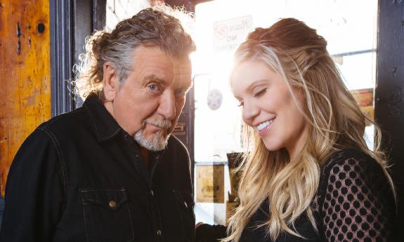 A photo of Robert Plant and Alison Krauss against a window