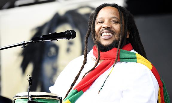 Stephen Marley smiles with a colorful scarf around his neck