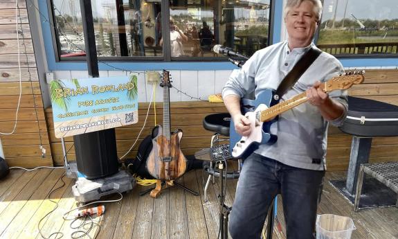 Brian Rowland performing at an outdoor venue