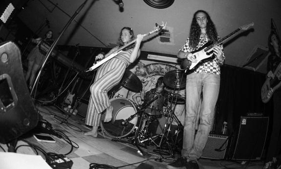 B&W shot from below - the five trendy members of Florida band Sun Child playing a show.