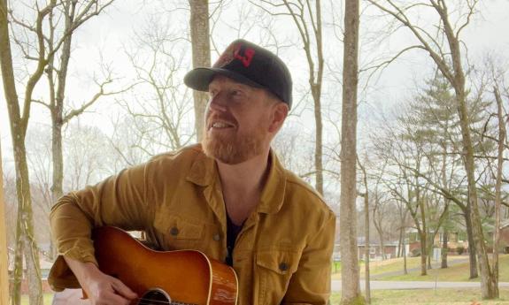 Steve Everett playing guitar outside in fall setting