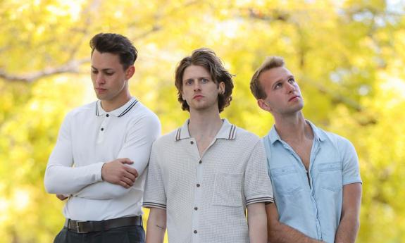 The band Summerdrive's three musicians standing in the woods