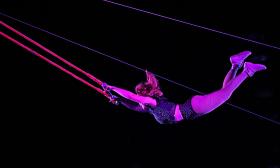 A trapeze artist in mid-performance