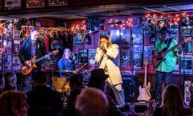 Jason Ricci plays the harmonica on stage with The Bad Kind music band. 