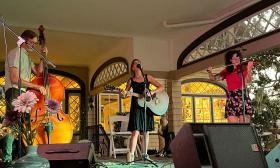 band SouthPaw, man on bass, woman on banjo, woman on fiddle, onstage