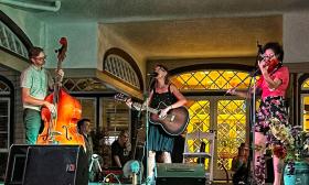 band SouthPaw, man on bass, woman on guitar, woman on fiddle, onstage