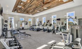 The fitness center includes an assortment of equipment and weights