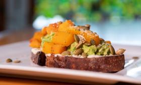 A plate of avocado toast with various toppings