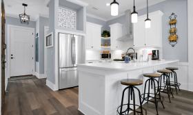A white kitchen with an eating counter in a vacation rental that's in Lincolnville
