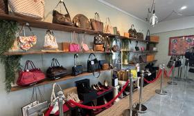 A selection of bags and shoes along the back wall