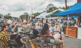 A crowd on Main Street in Hastings, Florida with vendor tents in the background