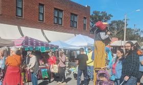 Vendors, shoppers, and performers on Main Street in Hastings, Florida