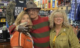 A Freddy Kruger figure with two staff members of Adamec Harley-Davidson