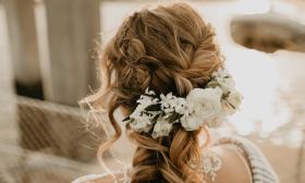 A half-up, half-down hairstyle decorated with white flowers