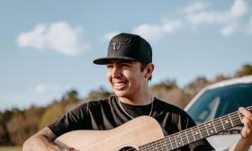 Singer/songwriter Hunter Hays with guitar, outside