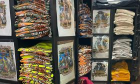 Harley-Davidson shirts with colorful art on display