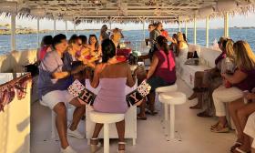 Celebrating a birthday at sunset aboard the "Exodos" pontoon boat