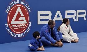 Students stretching before taking a jiu-jitsu class