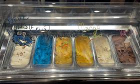 A glass display of assorted gelato flavors