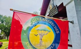 A vibrant flag from the Gullah Geechee nation waves freely outside the BRADLC Museum.