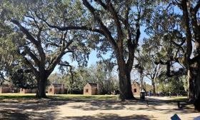 Visitors walk through Boone Hall Plantation on a sunny day. 