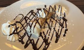 A cannoli drizzled with chocolate