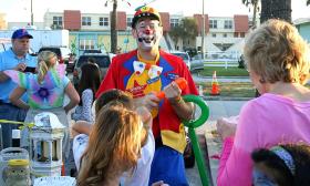 A clown crafting a ballon design