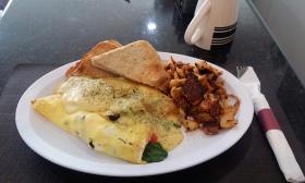 A plate of an omelet and sides