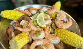 A platter of shrimp, corn, and sausage