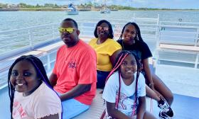 A family of five, with three daughters. aboard a tour boat 