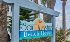 The colorful and carved sign for a boutique beach hotel