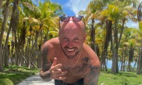 Musician Chase Rideman, in palm tree forest, smiling