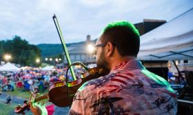 Fiddler with the Dave Matthews Tribute Band, onstage at a festival