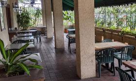 Patio seating with greenery around the space