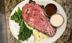 A plate of steak, mashed potatoes, and asparagus