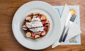 A waffle plate with various toppings