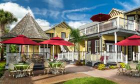 The garden, gazebo, and decks, all painted yellow and white with green trim, at this bed and breakfast