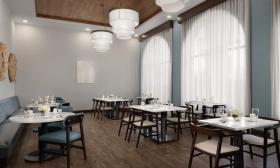 The dining area at this hotel has arched windows and a soft blue/grey color